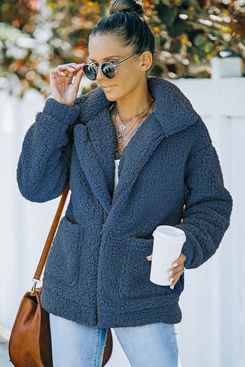 A model wearing the coat in blue