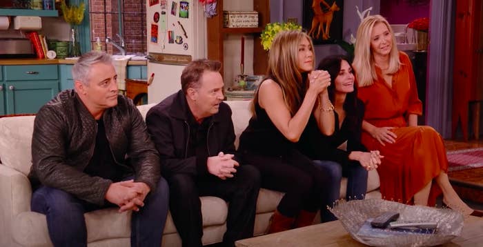The cast of Friends sitting on the show&#x27;s famous couch during the reunion show