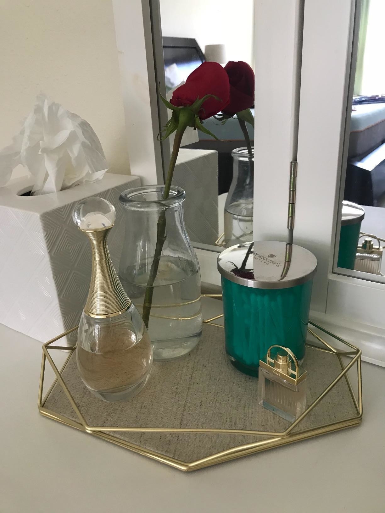 reviewer image of gold tray with small vases on it