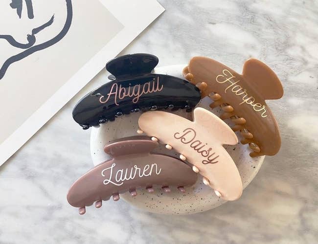 brown, black, and blush hair claws with names on them