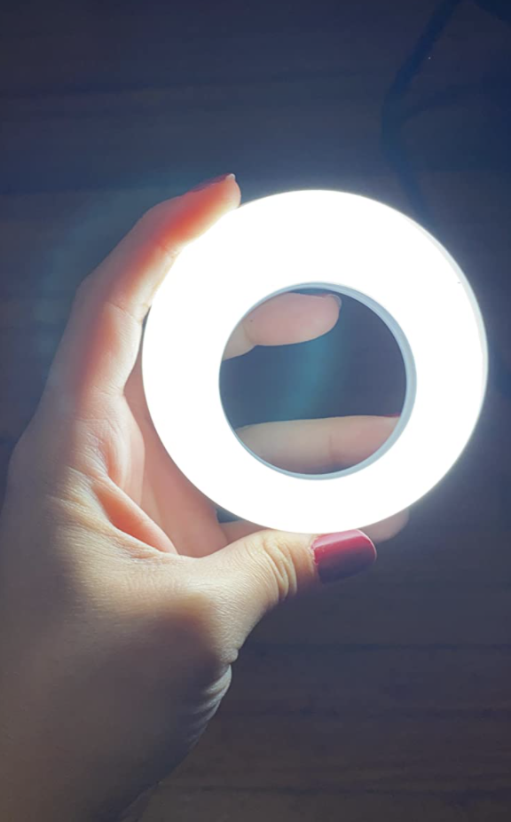 A customer review photo of them holding up the lit ring light
