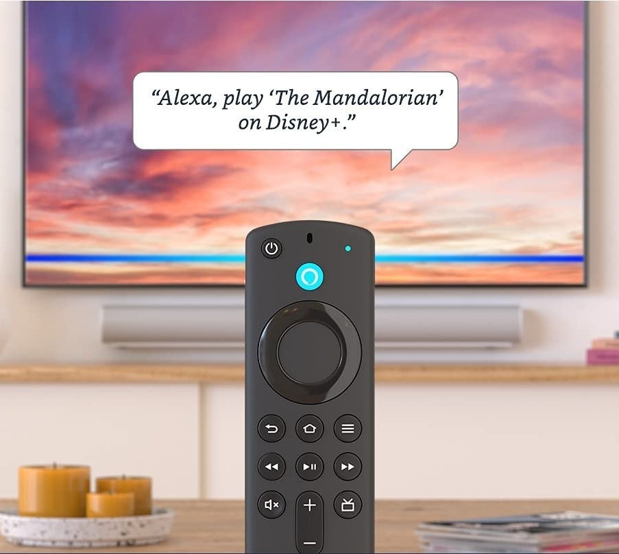 The FireStick in front of TV with dialogue that says &quot;Alexa, play The Mandalorian on Disney+&quot;