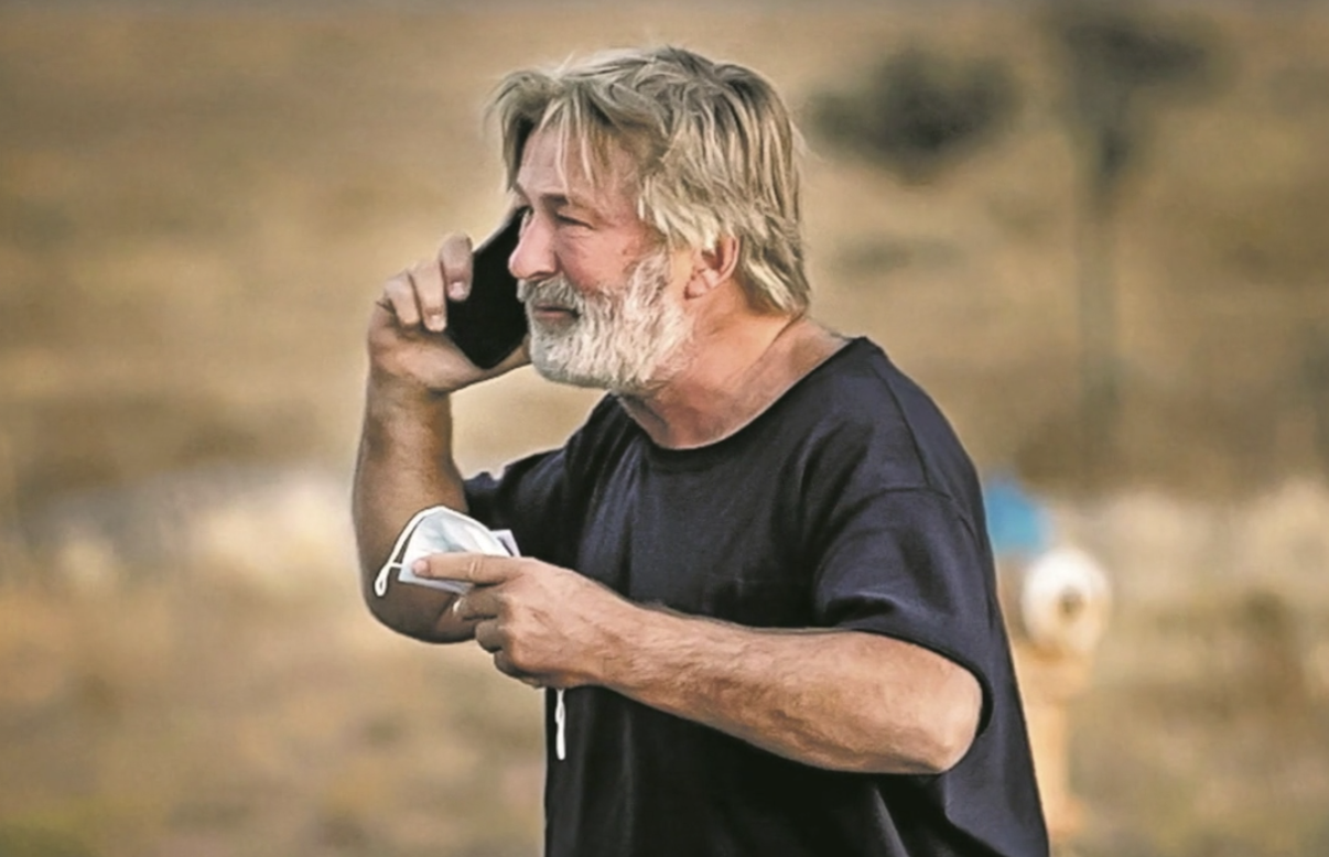 Alec Baldwin holding a phone up to his ear