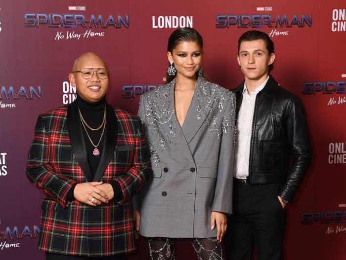 From left to right: John Balaton, Zendaya Coleman, and Tom Holland pose for photos on the red carpet at their film&#x27;s premiere