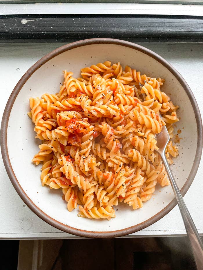 Bowl of steaming pasta with marinara sauce