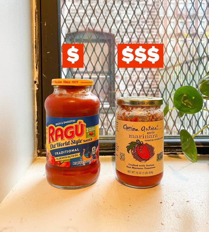 Ragu and Cucina Antica marinara sauces set on a window sill for comparison, the former with one dollar sign, the latter with three (to indicate price)