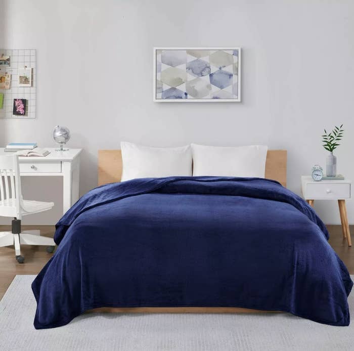 Royal blue plush blanket on bed in bedroom