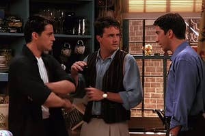 joey, chandler, and ross standing in monica's kitchen