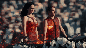 Peeta and Katniss riding in on their fiery chariot
