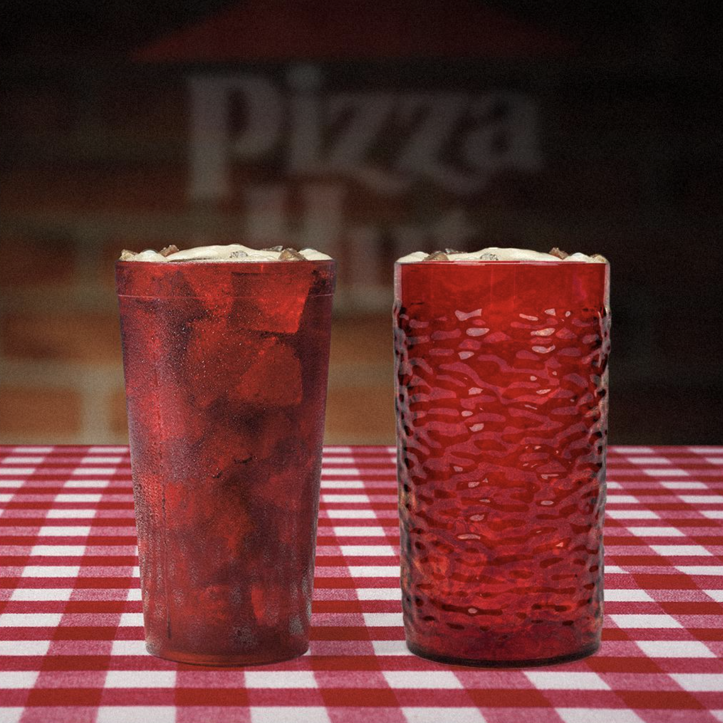 Two different Pizza Hut red plastic cups atop a red-and-white checkered tablecloth