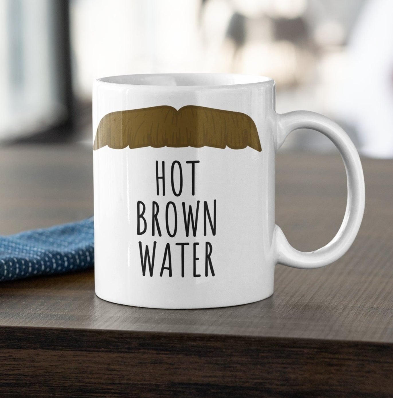 The Ted Lasso mustache mug that says &quot;hot brown water&quot;
