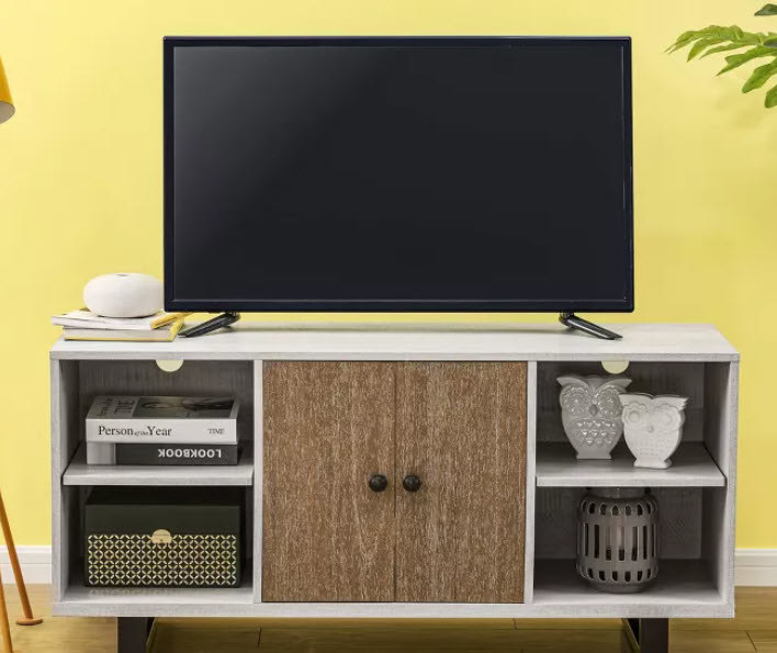 An all white TV stand with 4 cubbies and middle shelving with wooden double-doors. Can hold up to a 50&quot; TV and is good for small spaces!