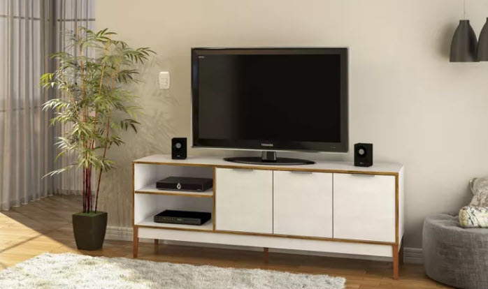 All white TV stand with brown wooden borders and tons of storage. Standing on 4 wooden legs and includes open shelving.