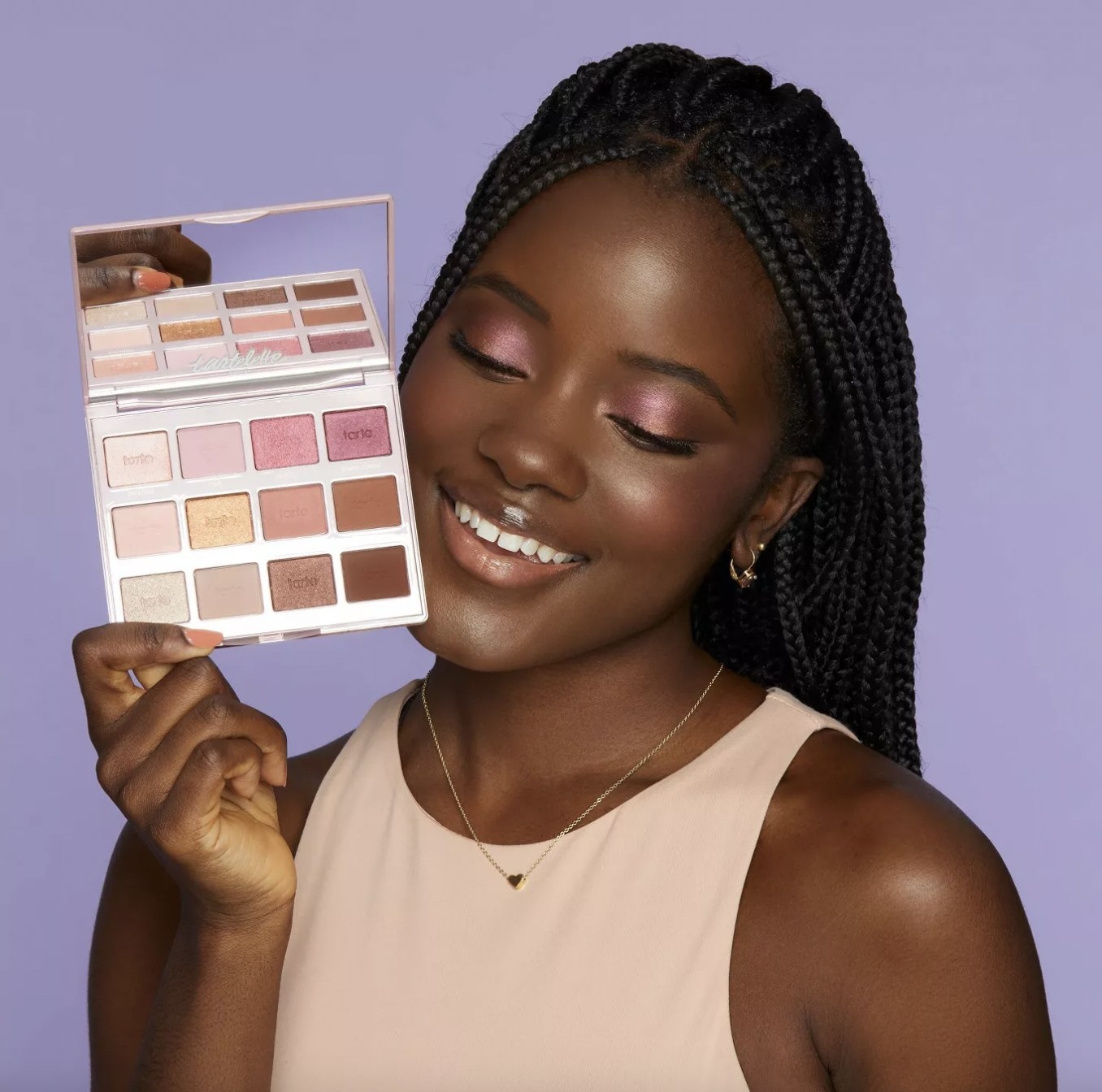 A person holding an eyeshadow palette