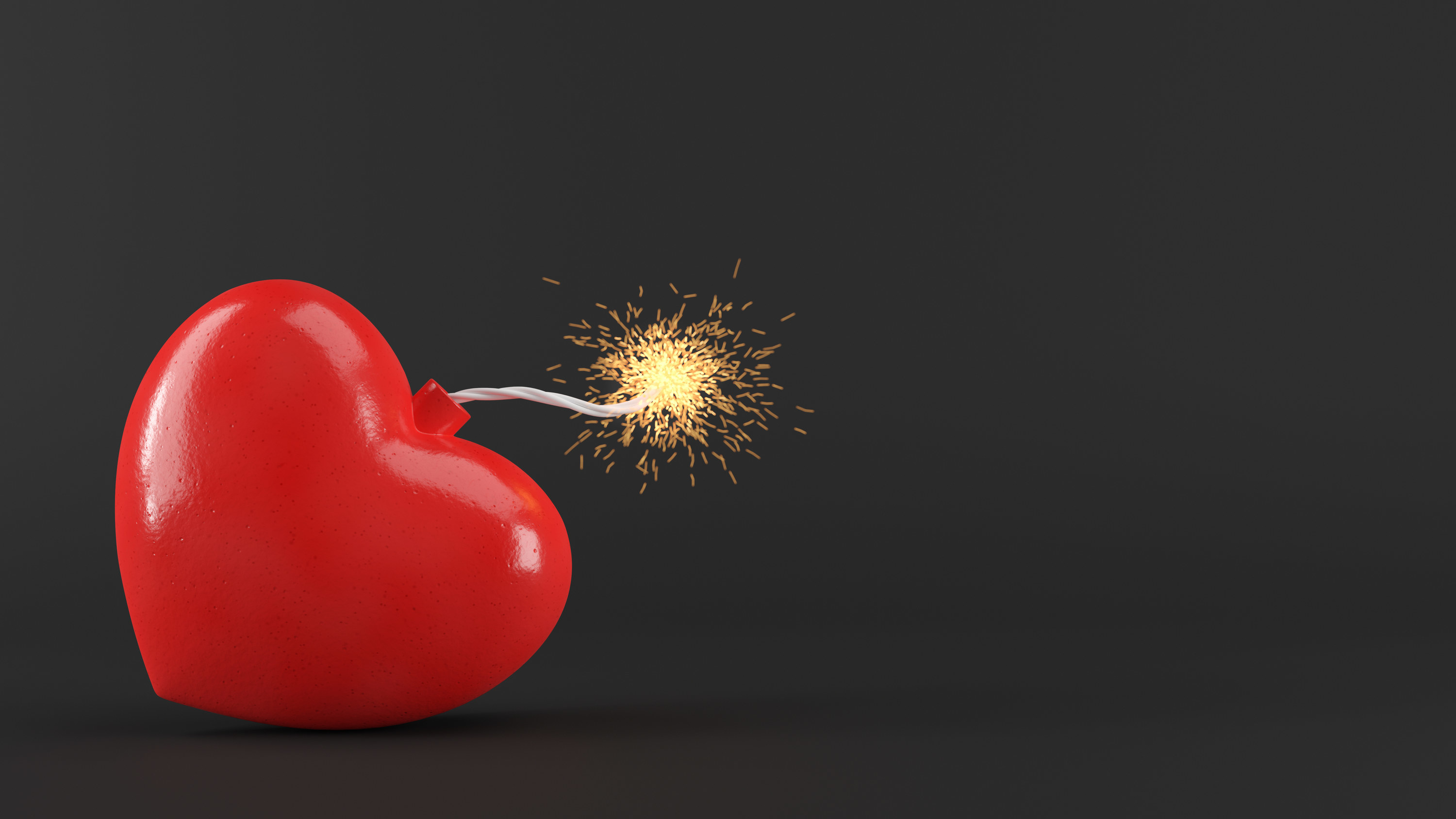 A heart-shaped bomb with a lit fuse