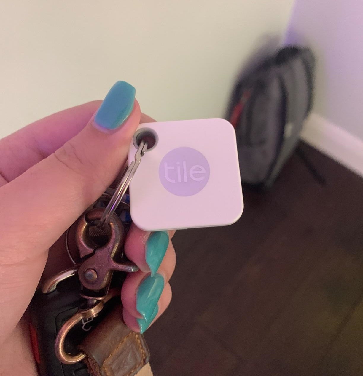 a reviewer shows their tile mate on a set of keys