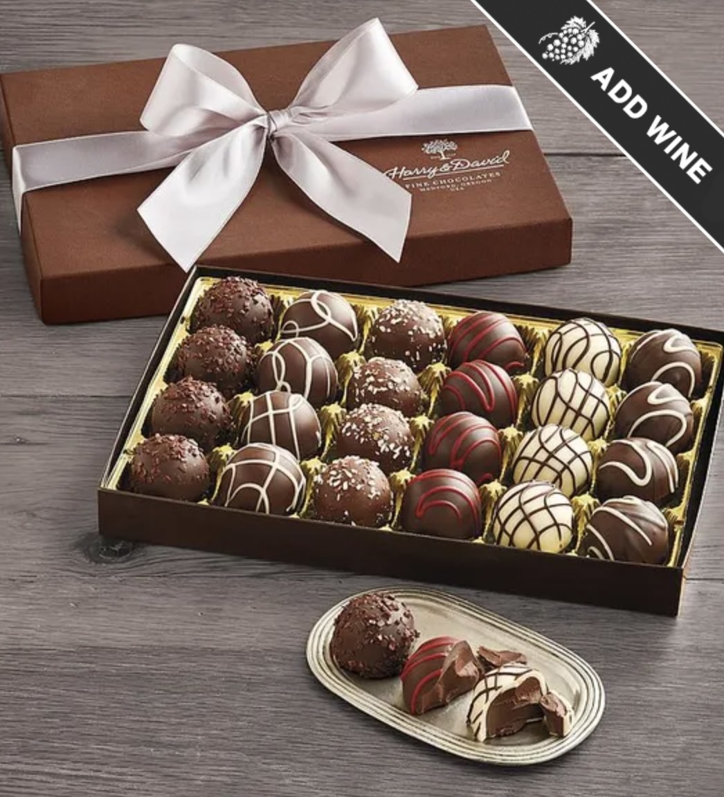 The open box of 24 truffles with three set out on a plate