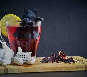 The cat-shaped tea diffusers in use