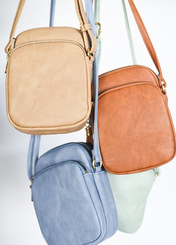 The beige, tan, blue, and green crossbody bags