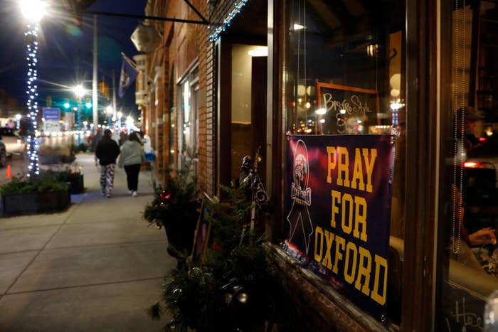 A sign in a storefront window reads &quot;pray for Oxford&quot;