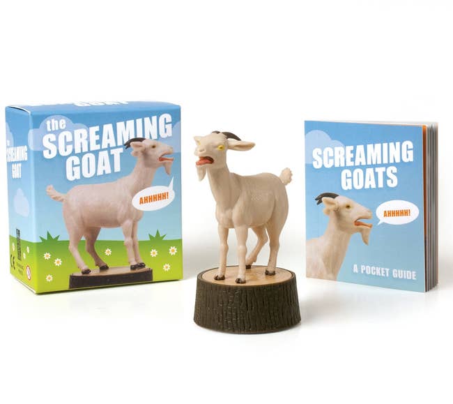 The screaming goat figure next to its box and mini book
