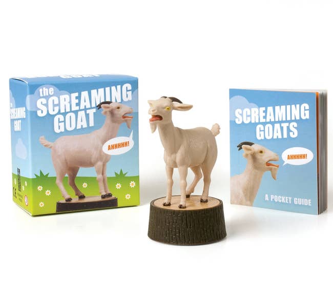The screaming goat figure next to its box and mini book