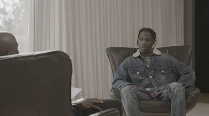 Travis sits in a chair facing Charlamagne