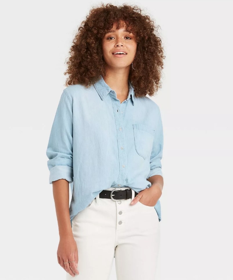 A model wearing a long sleeve denim shirt