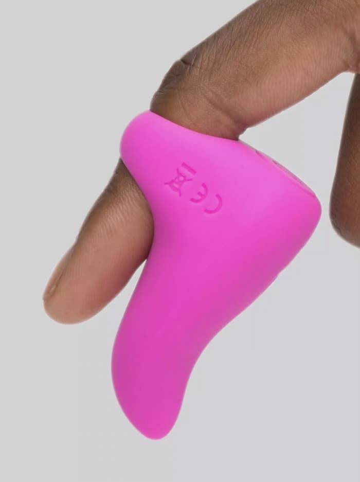 the pink vibrator on an index finger