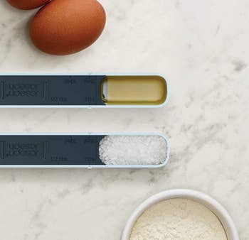 adjustable measuring spoon with wet and dry ingredients in it