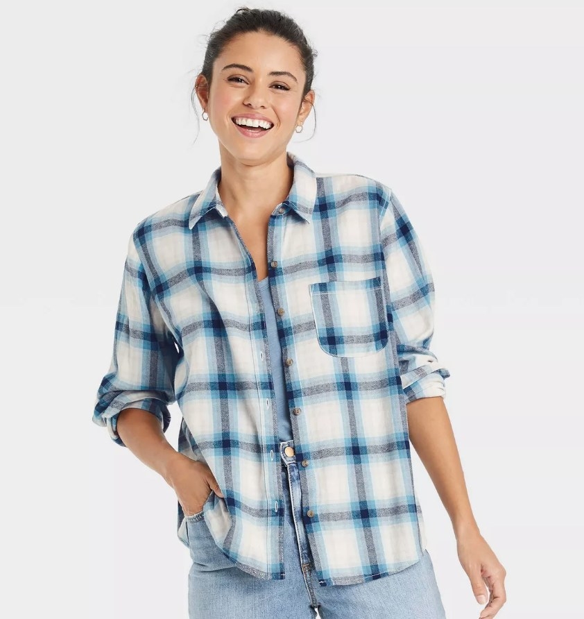 A model wearing a navy plaid button-down flannel