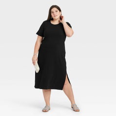 model in the round-neck black midi dress with slits up the sides