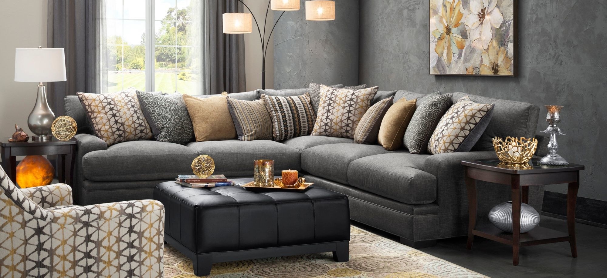 a gray sectional sofa with tons of throw pillows on it