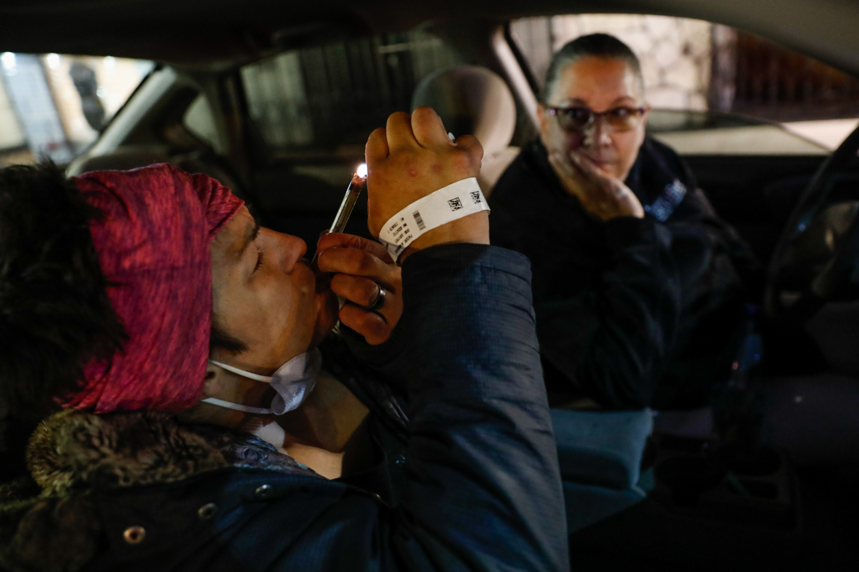 a woman does drugs in a car while her mother watches