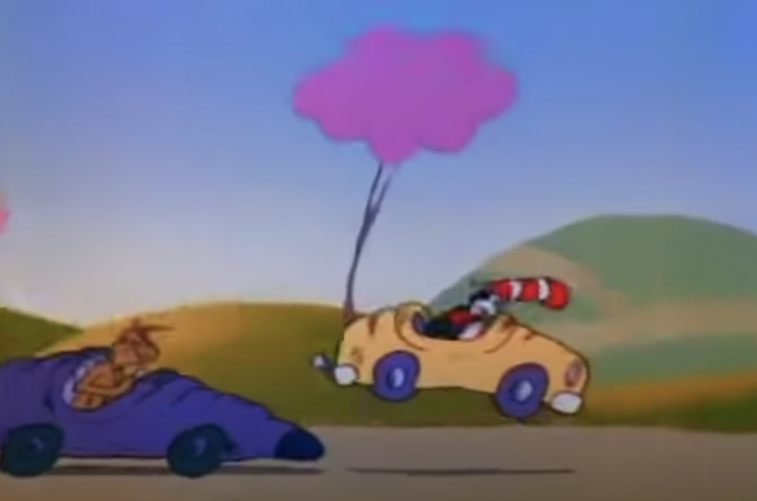 The Grinch ramming into the back of the cat's car, causing the car to jump up