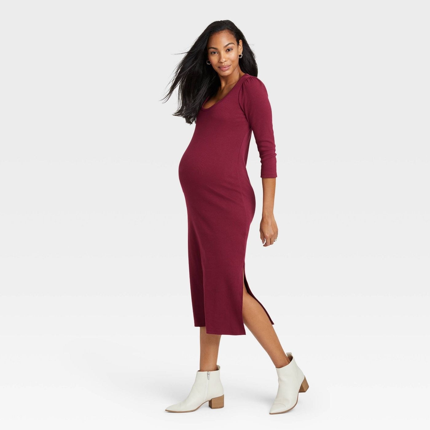 model with a baby bump in a merlot colored tee dress with slits up the sides