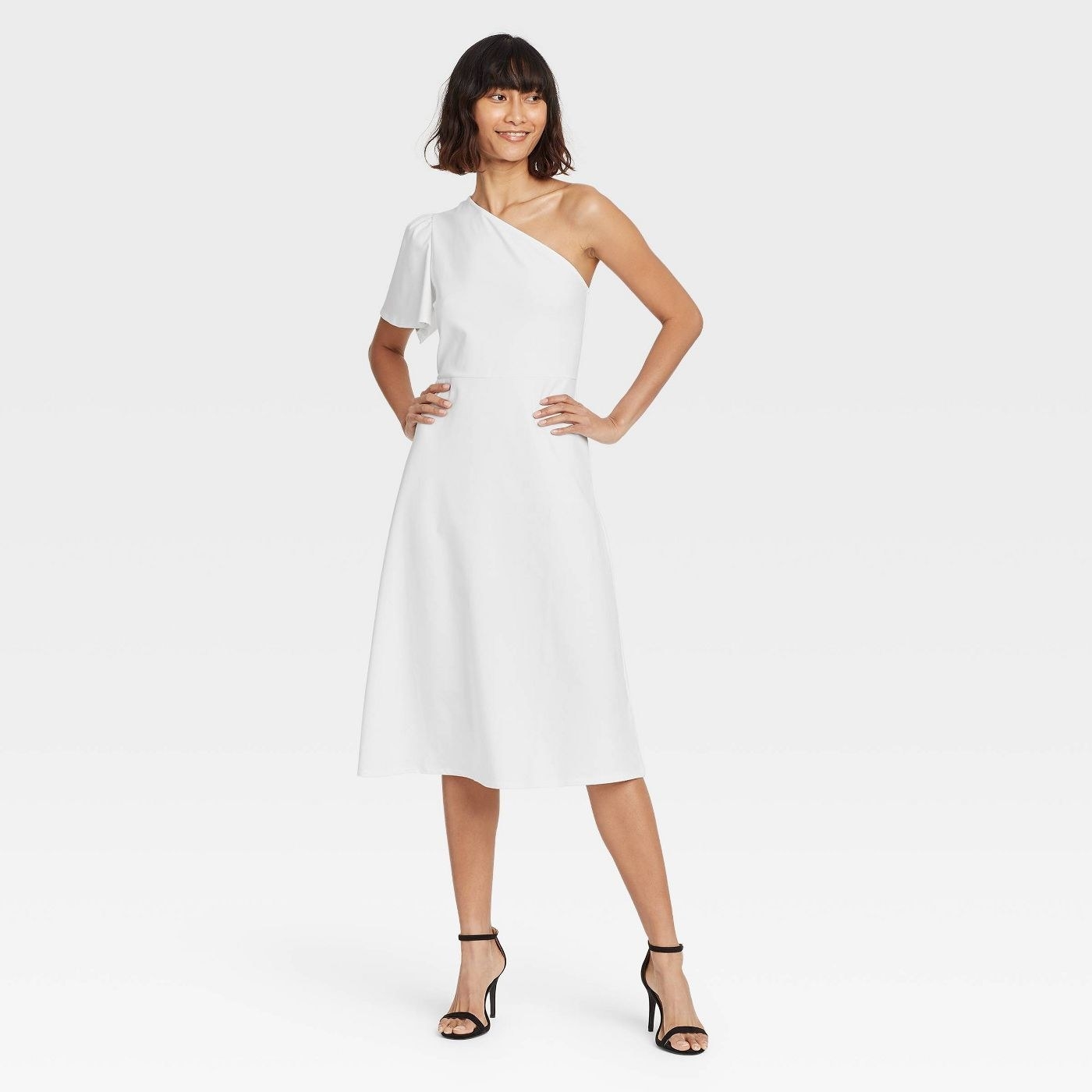 model in white midi dress with one ruffles sleeve