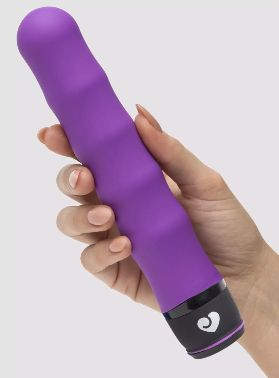 The purple vibrator with ribbed texturing along the body