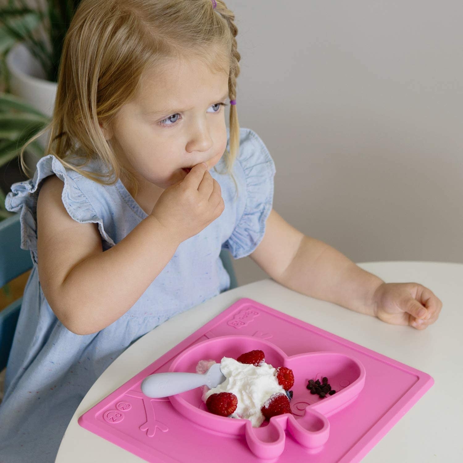 small child eats out of pink silicone peppa pig m