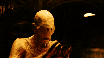 GIF of  the Pale Man, who has eyes on his hands from Pan&#x27;s Labyrinth