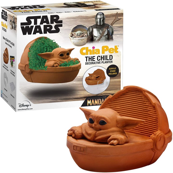 The baby yoda chia pet next to its box