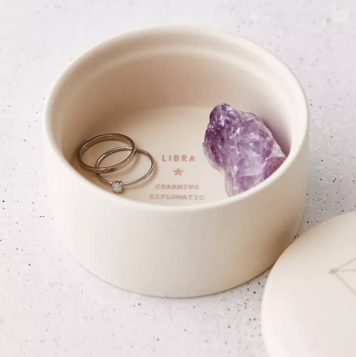 libra trinket dish filled with a crystal and rings
