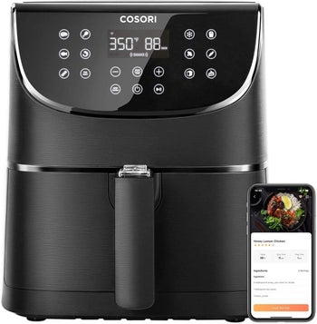 air fryer with recipe on phone next to it