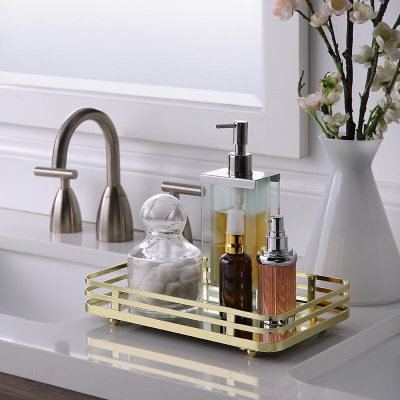 the gold-tone tray holding essentials on a countertop