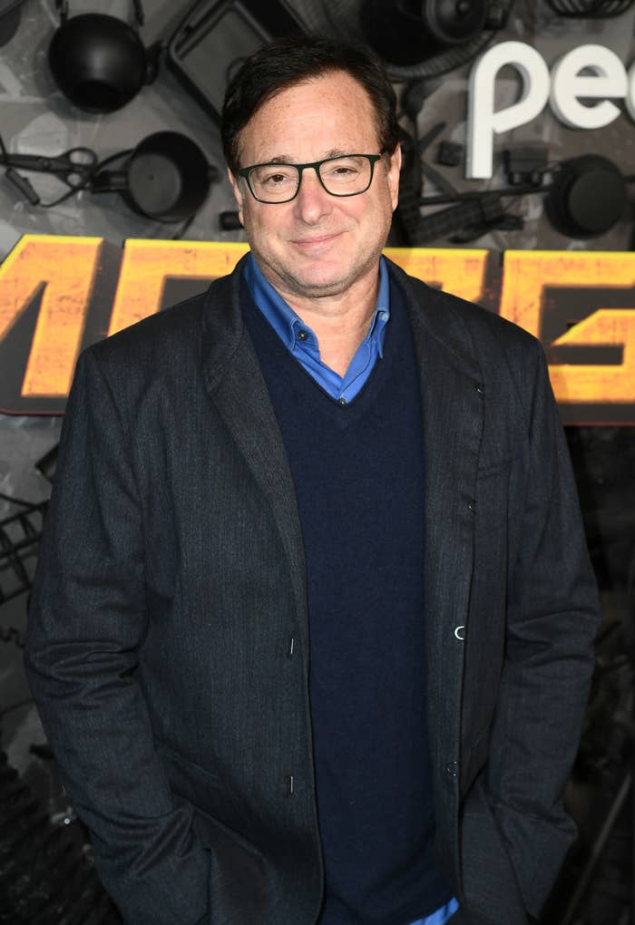 Bob Saget with his hands in his pocket at an event