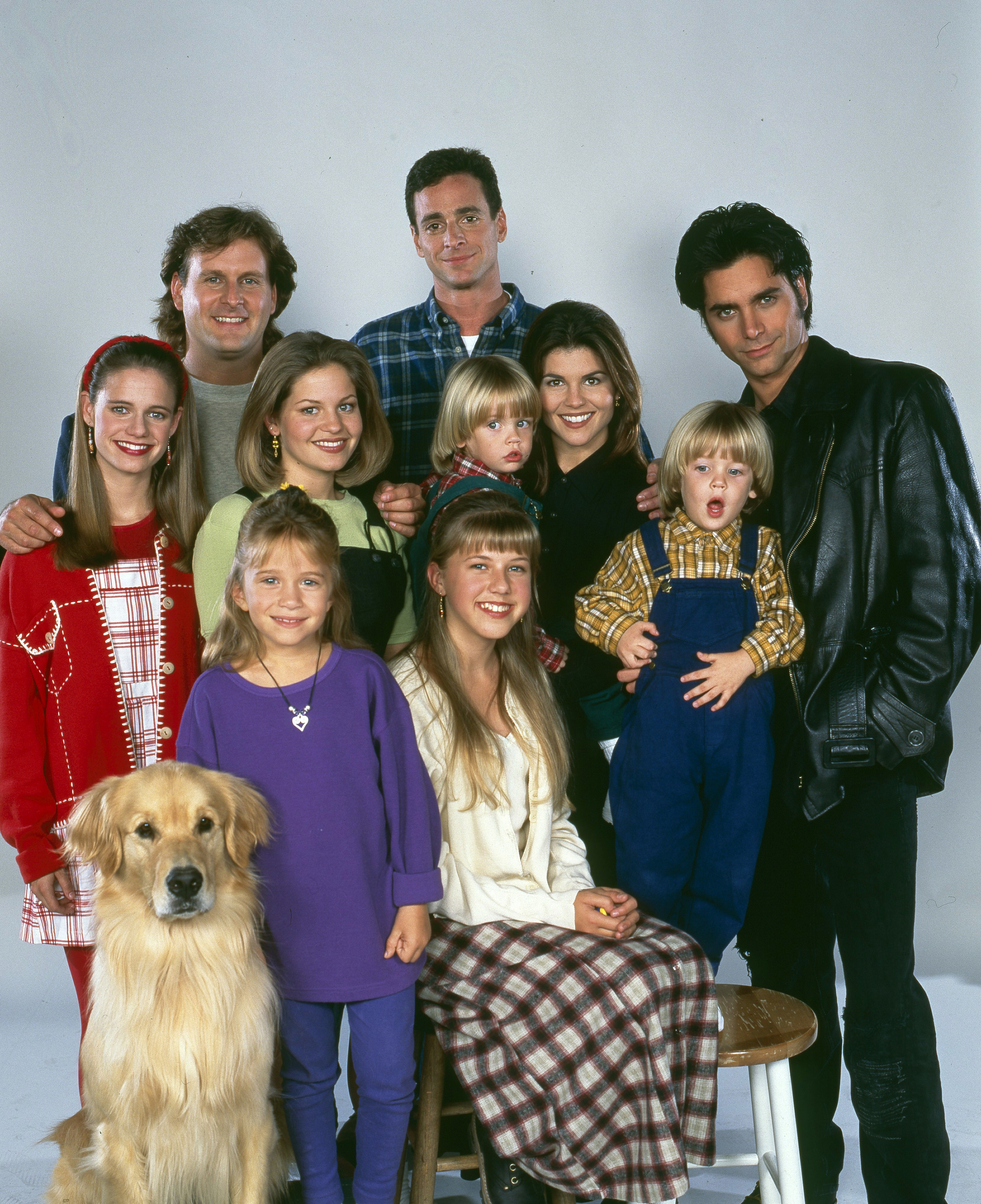 Andrea Barber, Dave Coulier, Mary-Kate Olsen/Ashley Olsen, Candace Cameron, Jodie Sweetin, Dylan Tuomy-Wilhoit/Blake Tuomy-Wilhoit, Lori Loughlin, and John Stamos pose in a promotional photo for Full House