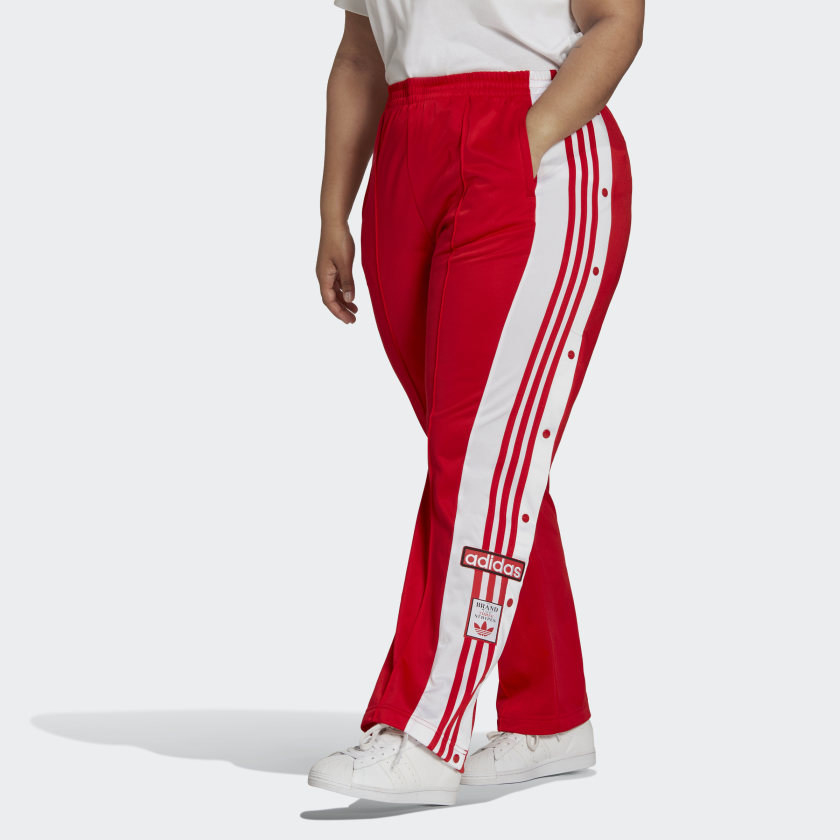 Model wearing red and white pants, white sneakers and white top
