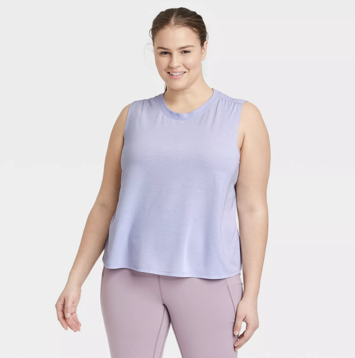 Model is wearing a lavender tank top and light pink pants