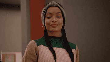 Yara Shahidi brushing her shoulders as Zoey Johnson in