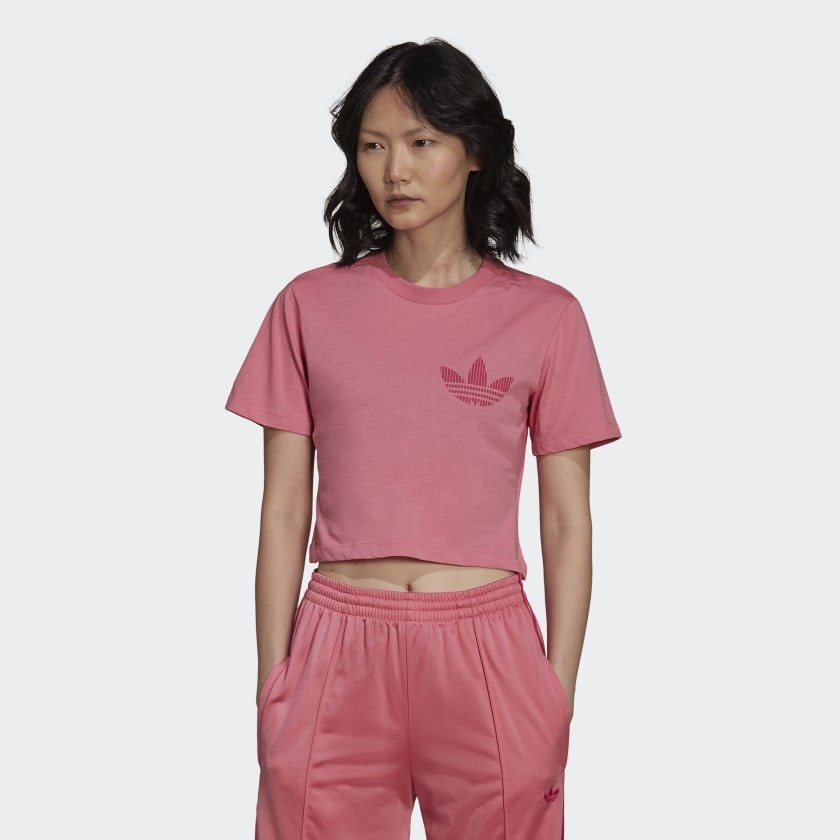 Model wearing pink cropped tee with matching pants